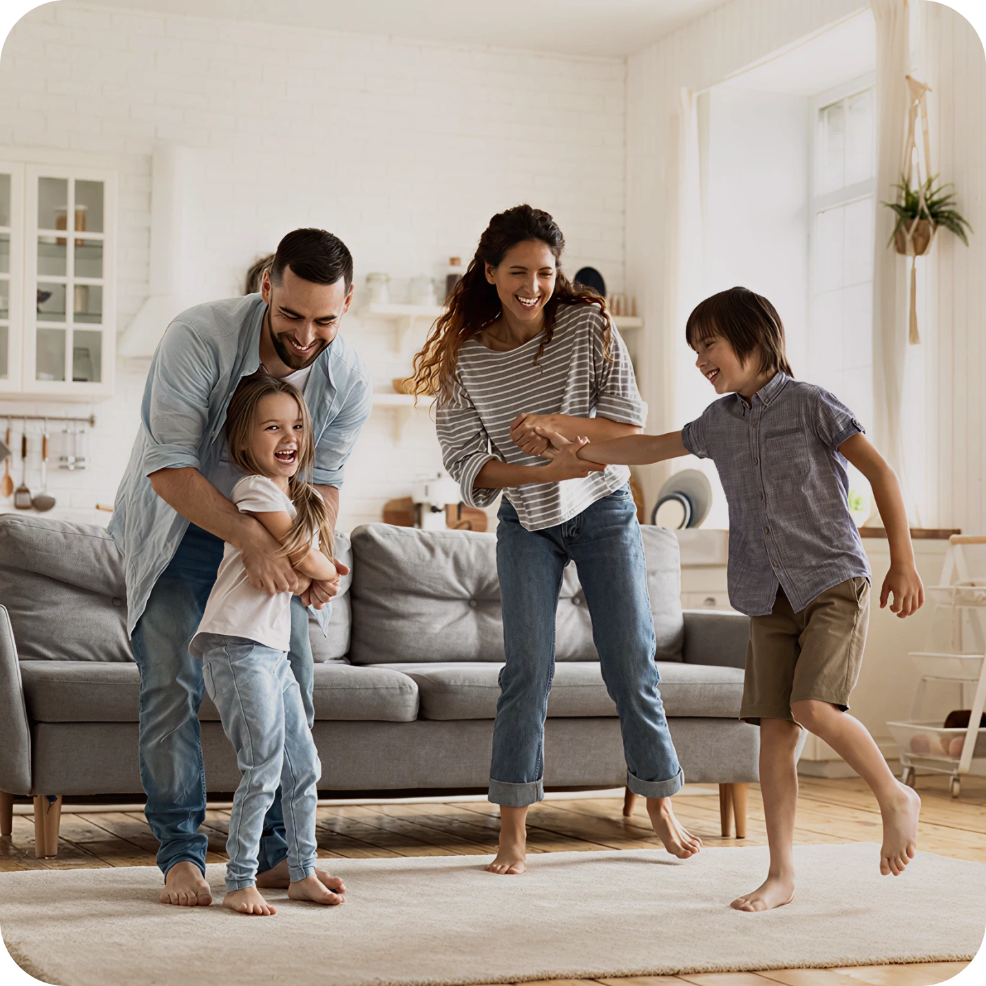 Smiling family sitting in a living room with natural light