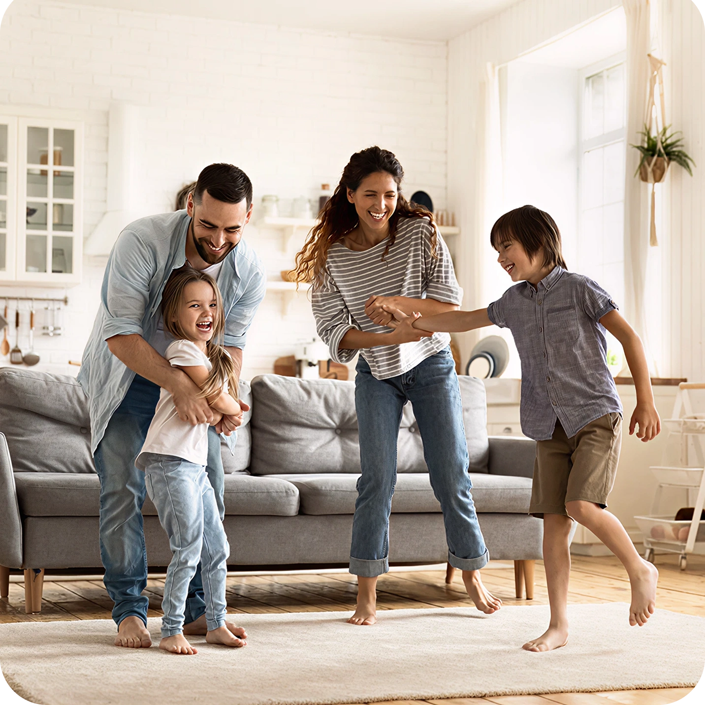 Smiling family sitting in a living room with natural light
